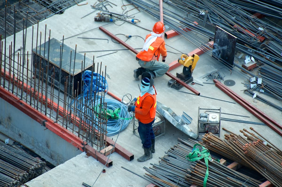Construction site with steel framework and workers building a commercial structure
