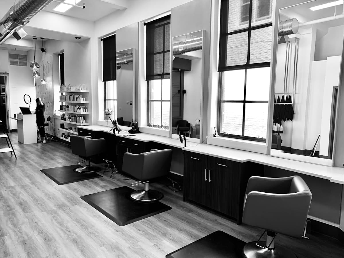 Modern hair salon interior with styling chairs and mirrors ready for clients
