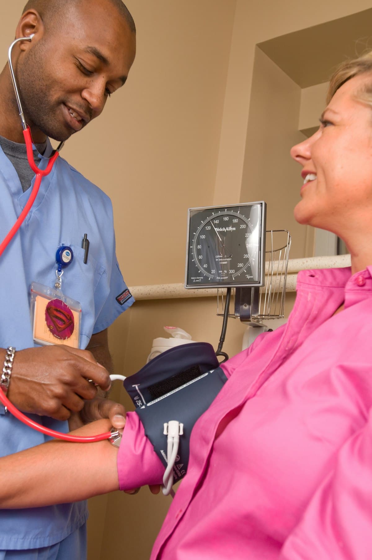 Doctor in white coat standing in modern medical office with examination equipment